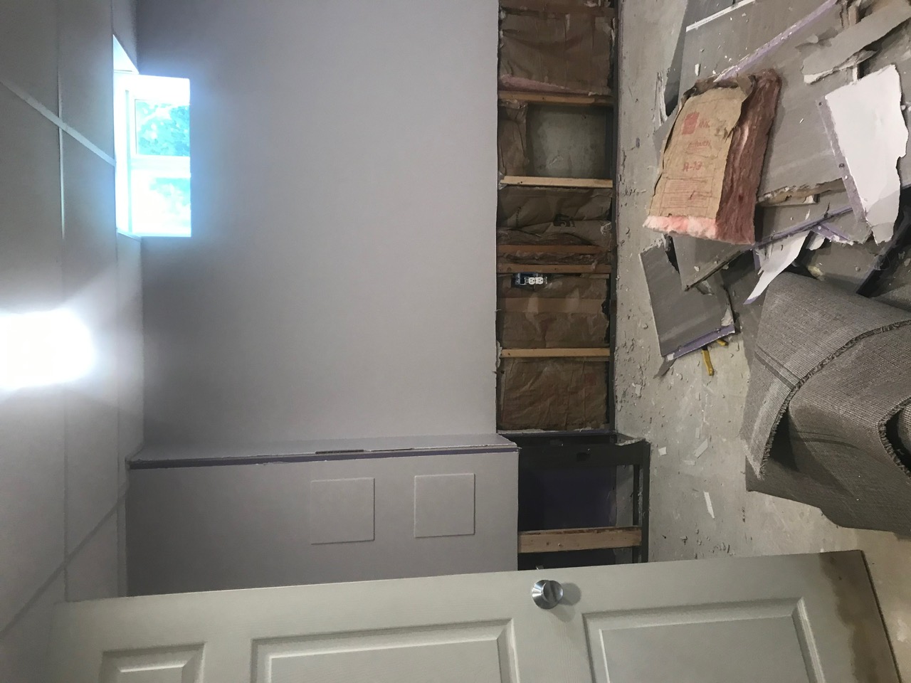 Basement gutted — wall opened to the studs and old materials cleared out at the start of the job.