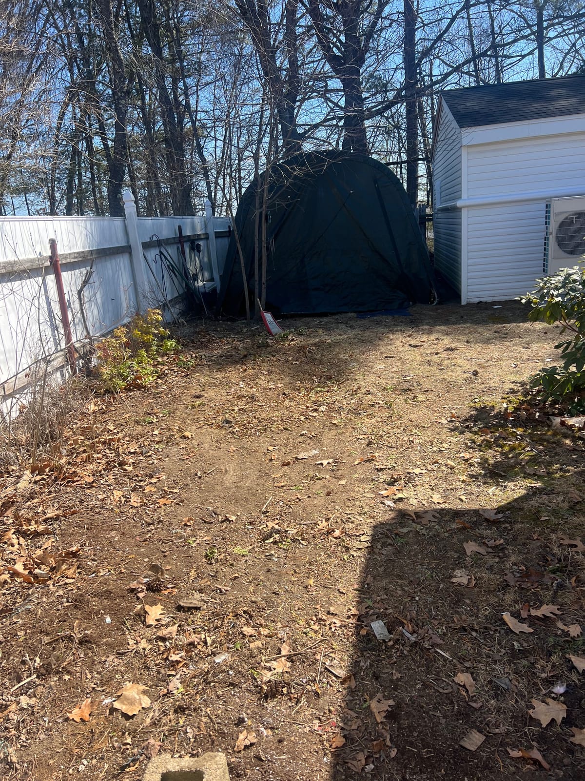After: backyard packed with discarded furniture and household items, then cleared down to bare lawn